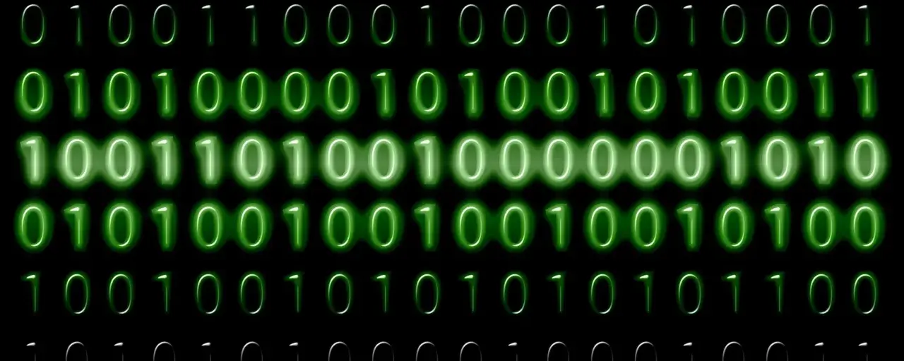 Sequenze di zeri e uno verdi brillano su sfondo nero. Il codice binario, che rappresenta il mb significato, scorre in righe.
