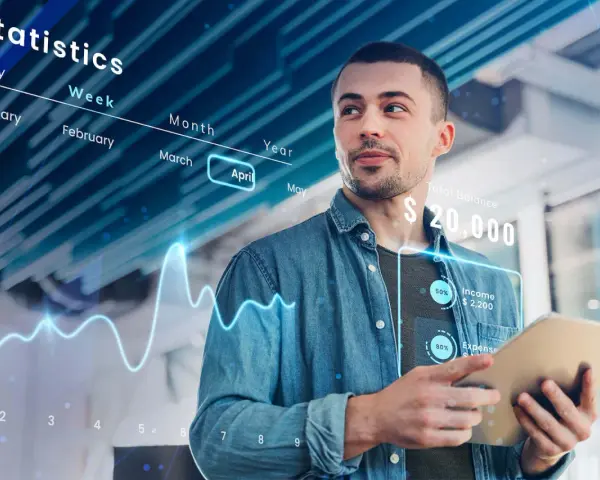 Uomo analizza dati finanziari su tablet, con grafici e statistiche che illustrano cosa sono i sistemi ERP e la gestione aziendale.