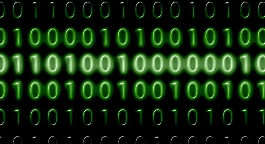 Sequenze di zeri e uno verdi brillano su sfondo nero. Il codice binario, che rappresenta il mb significato, scorre in righe.
